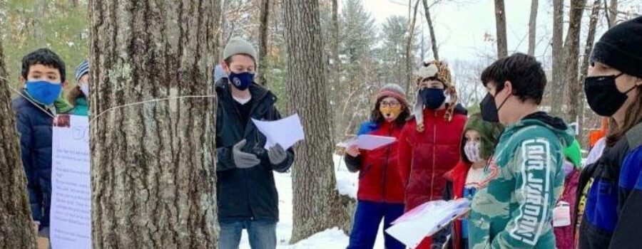 students taking a walk in the snowy woods