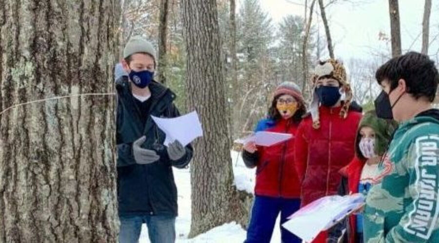 students taking a walk in the snowy woods